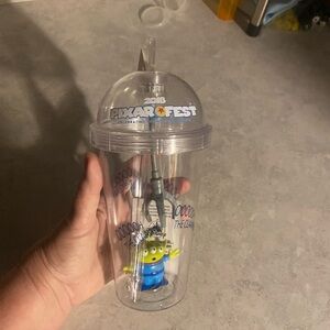 Disney Pixar Fest Clear Tumbler with Green Alien Figurine and Blue Outfit